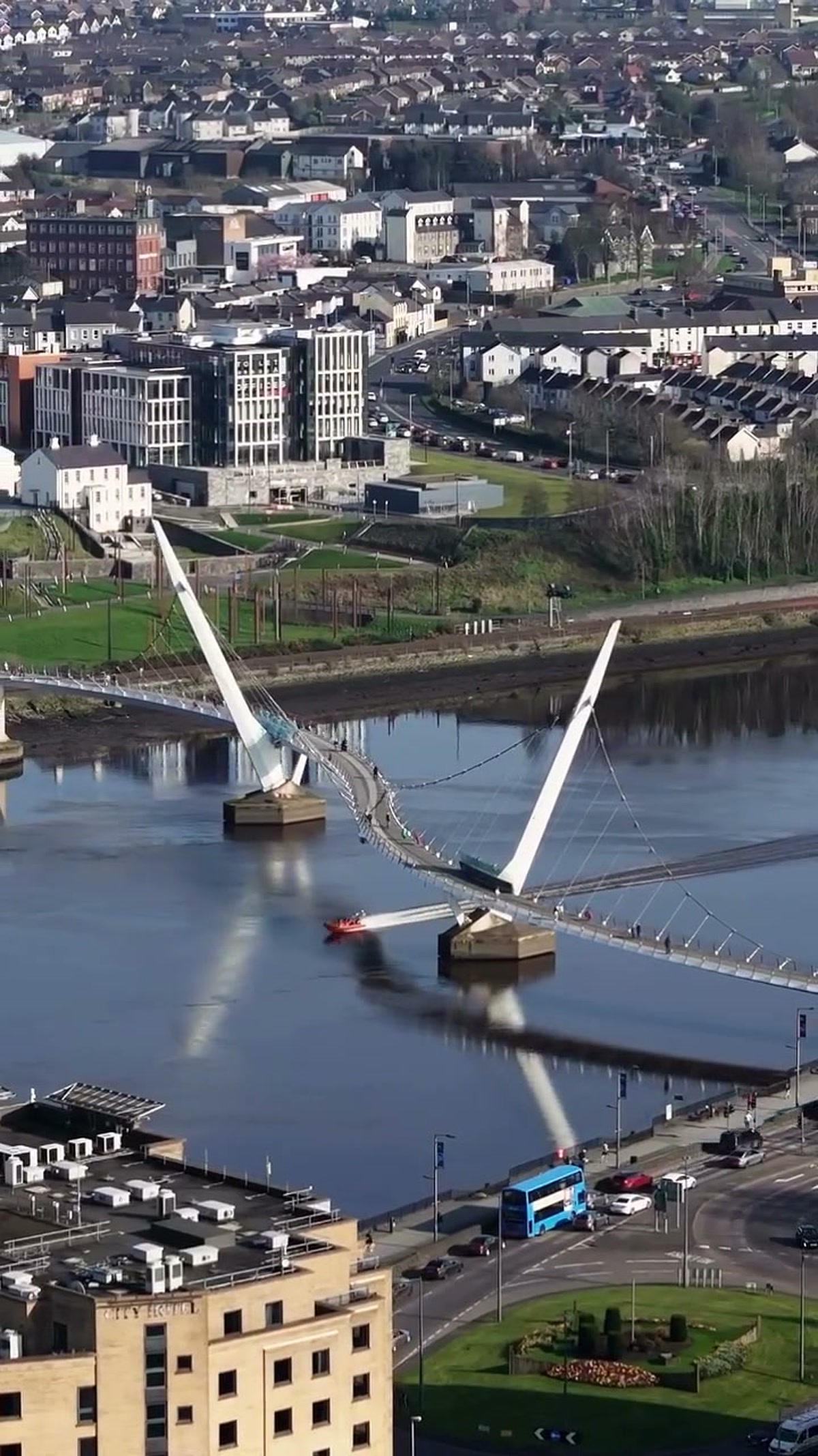 Phantom drone still of a red RIB passing under the Peace Bridge in Derry/Londonderry, captured on a property shoot