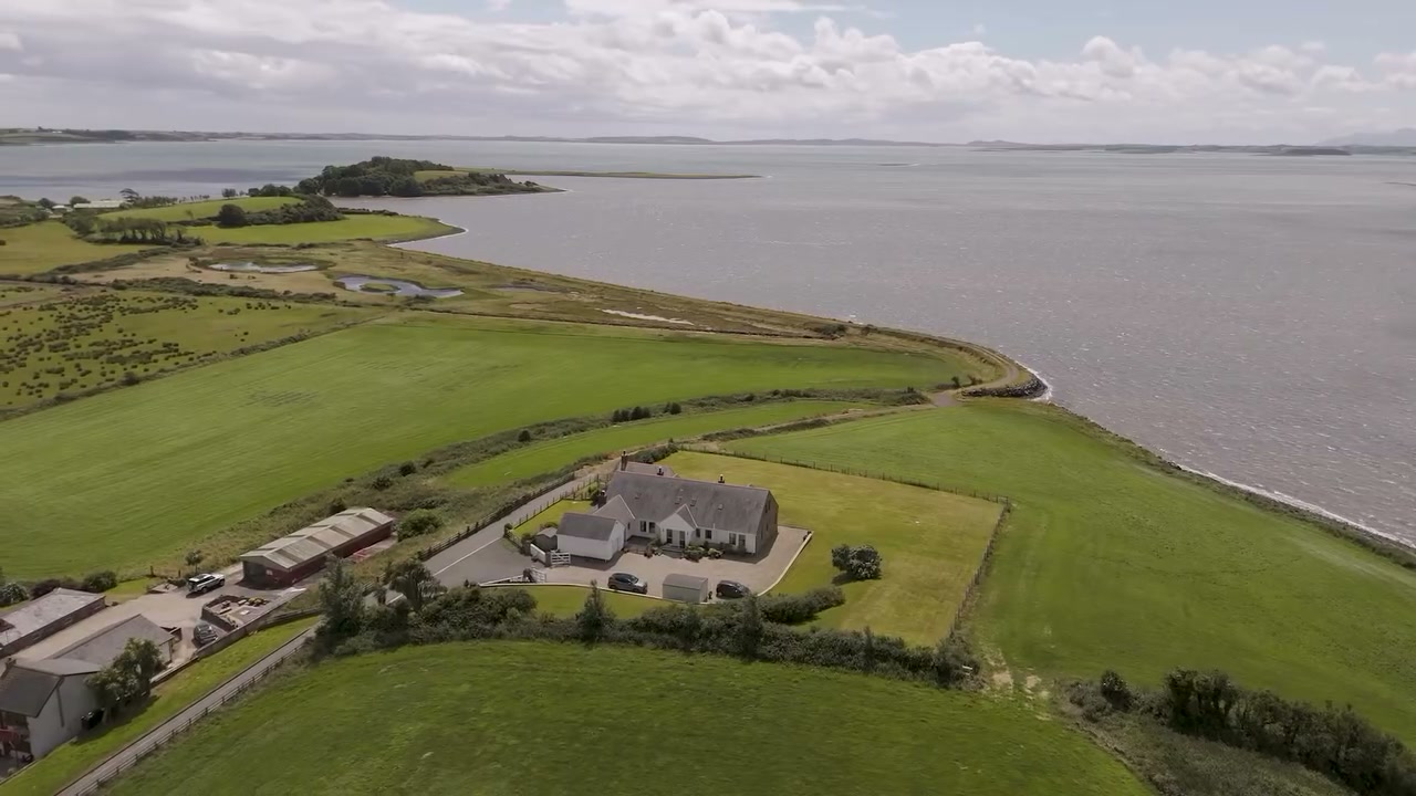 Phantom aerial drone film still of Shoreline, a lough-shore home at Greyabbey on the Ards Peninsula, captured in coastal wind