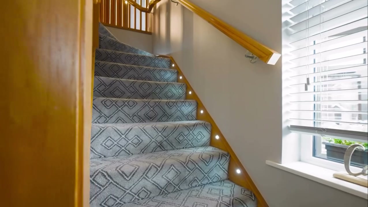 Cinematic Phantom film still of a five-bedroom detached family home in Belfast captured at dusk with warm interior lighting